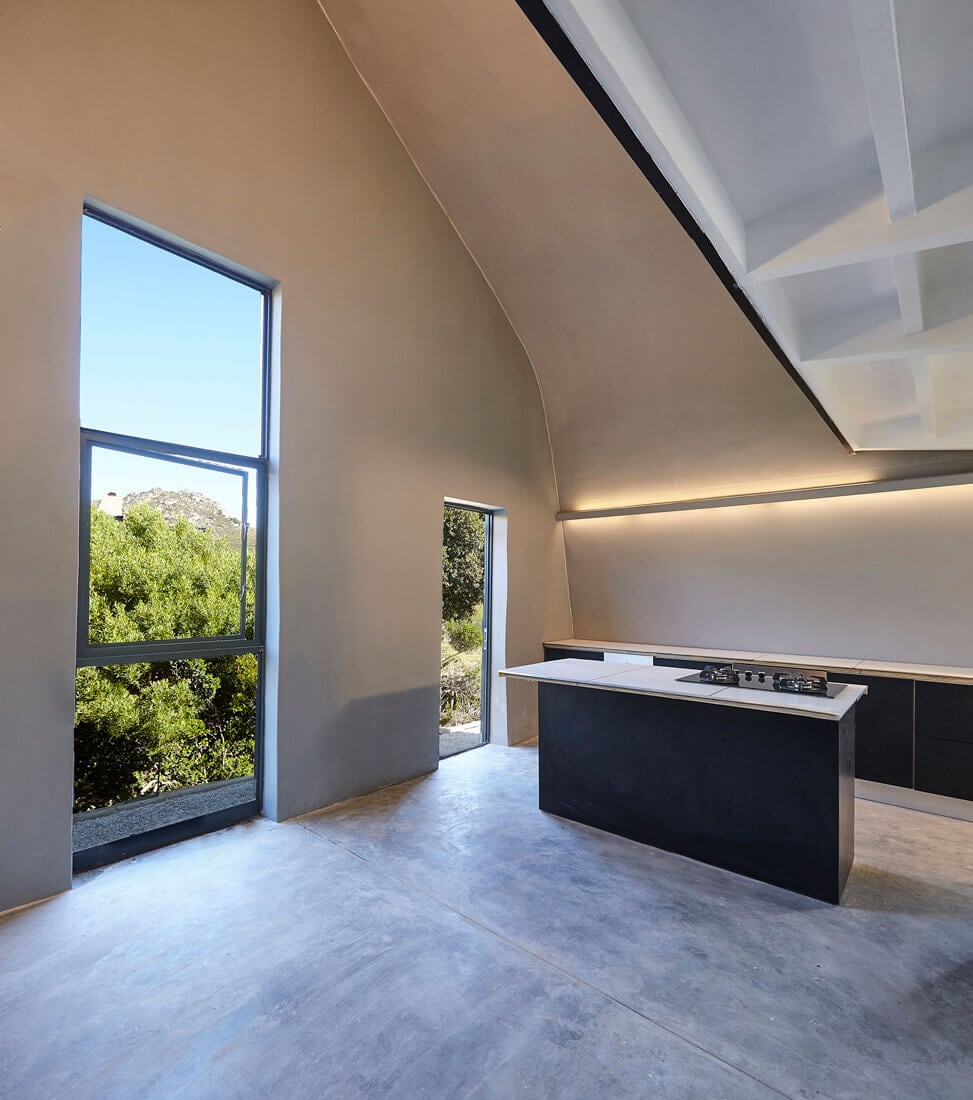 Modern minimalist kitchen with large windows and sleek design for contemporary living.