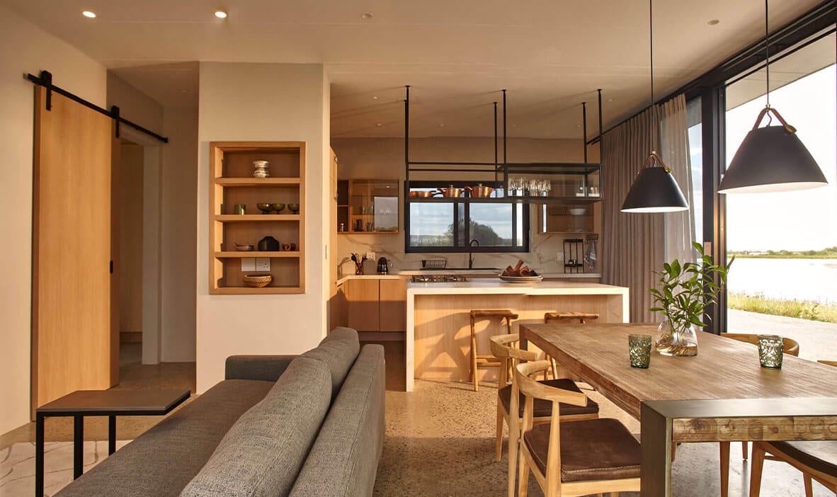 Spacious open-concept kitchen and living area featuring contemporary design and large windows for na.