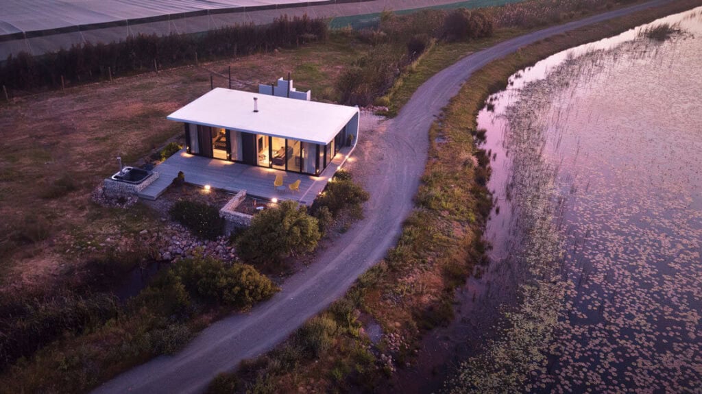 Modern lakeside house with scenic water views and surrounding nature in a peaceful setting.