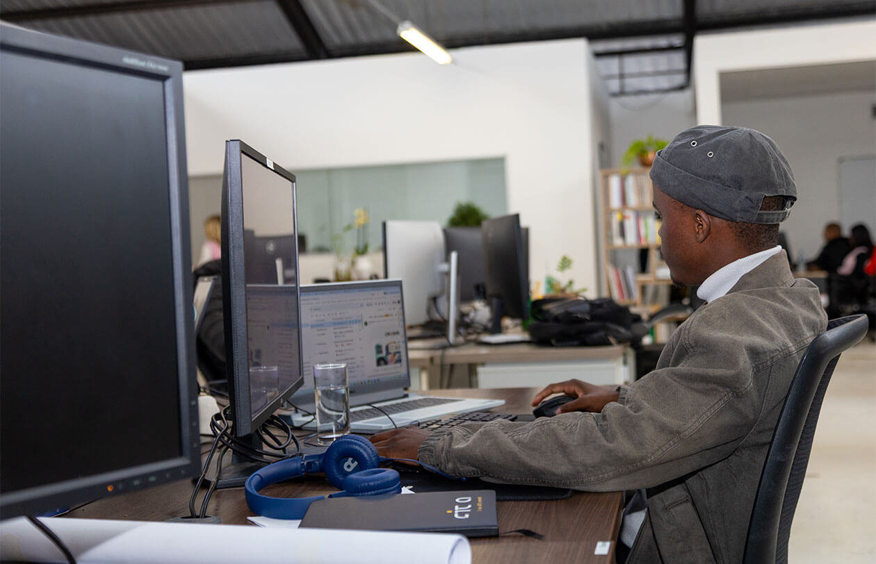 Careers Office worker focused on computer screen in a contemporary workspace environment.
