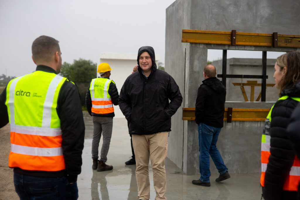 Mayor Geordin Hill-Lewis at CentralBlue development standing in front of a Citra building under construction.
